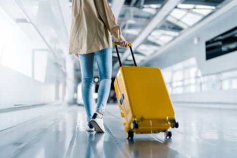 Woman walking through airport terminal