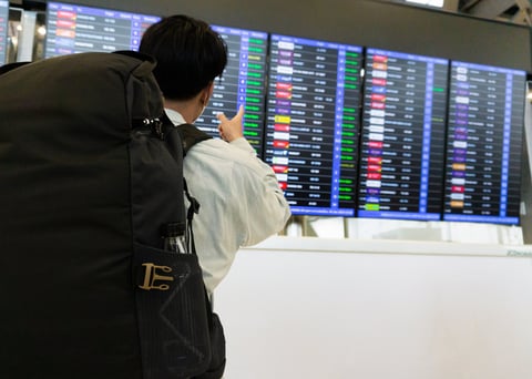 Man looking at departure board